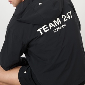 Model wearing 247 Represent Team Casual Jacket in Jet Black, back view showing bold Team 247 Represent logo print.