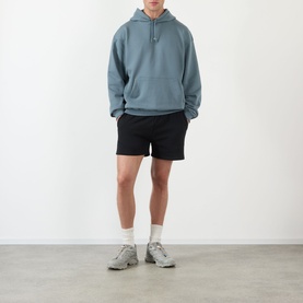 Model wearing 247 Dusky Navy hoodie with black shorts and grey trainers with white socks.