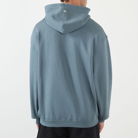 Model wearing 247 hoodie in dusky navy, rear view, oversized fit, kangaroo pocket, small logo at upper back