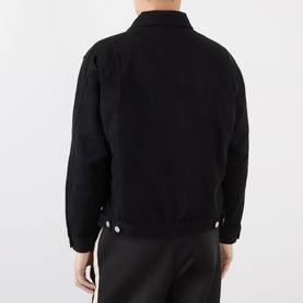 Model wearing Almost Home OG Twill Jacket in Storm Black, rear view showing dropped shoulders and adjustable waist tabs, styled with black trousers.