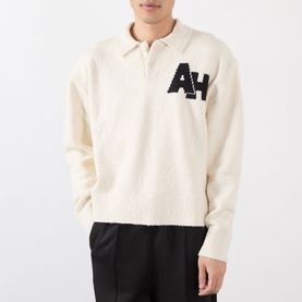 Model wearing Almost Home Cloudskin cotton polo with AH logo knit detail, styled with black trousers