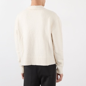 Model wearing Almost Home Cloudskin cotton polo knit, rear view, styled with black trousers with side stripe detail