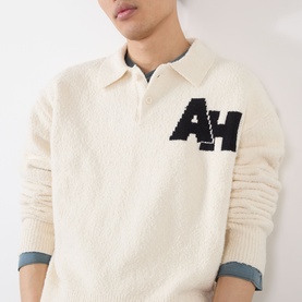 Model wearing Almost Home Cloudskin cotton polo with navy AH intarsia logo, styled with a denim collar underneath