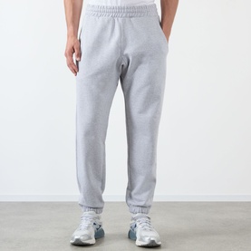 Model wearing Almost Home Workwear Logo Sweatpants in Gym Grey, tapered fit with cuffed ankles and elasticated waistband, styled with white trainers
