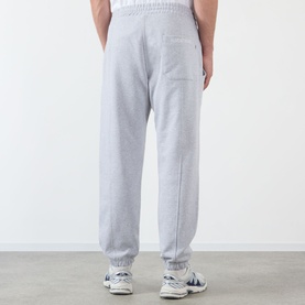 Model wearing Almost Home Workwear Logo Sweatpants in Gym Grey, tapered fit with cuffed ankles and logo embroidery, styled with white trainers
