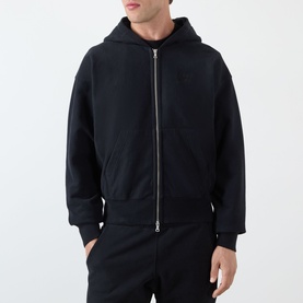 Model wearing Almost Home Workwear Logo Zip Hoodie in Porto Black, full-zip, fixed hood, ribbed trims, styled with matching joggers.
