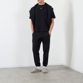 Model wearing Almost Home Workwear Logo T-Shirt in Porto Black with matching black joggers and grey suede trainers