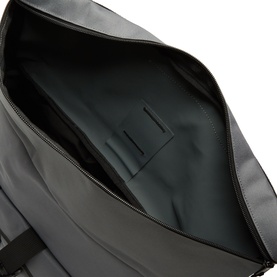 Carhartt Philis Logo Backpack in Styx, showing open main compartment interior with embossed logo detail and smooth black lining.