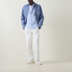 Model wearing Carhartt C-Logo Logo Patch Pocket Shirt in Bleach/White, styled with white trousers and white trainers.