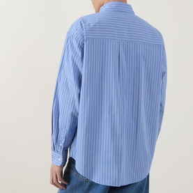 Model wearing Carhartt Keene Stripe Shirt in Curacao blue stripe, rear view showing wide box pleat, long sleeves and single cuffs, styled with jeans