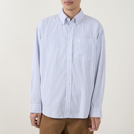 Model wearing Carhartt Casual Shirt in Keene Stripe/White, blue vertical stripes, button-down collar, chest pocket, paired with tan trousers