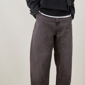Model wearing Carhartt OG Double Knee Straight Jeans in Tobacco, showing double-knee detail, tool pockets and bartack stitching, styled with black