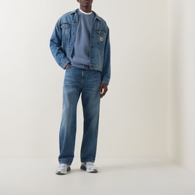 Model wearing Carhartt Caspian Sweatshirt in Shady Blue Heather, styled with a blue denim jacket, matching jeans and grey trainers.