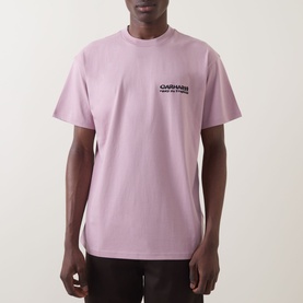 Model wearing Carhartt Cubist Logo T-Shirt in Hortensia pink, crew neck, short sleeves, with black chest graphic print.