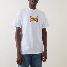 Model wearing Carhartt Road Side Snack T-Shirt in white with chest graphic print, styled with blue jeans