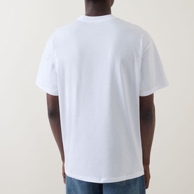 Model wearing Carhartt Road Side Snack T-Shirt in white, rear view, crew neck, dropped shoulders, short sleeves, styled with blue jeans.