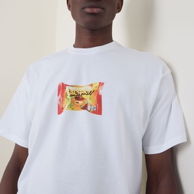Model wearing Carhartt Road Side Snack T-Shirt in white with chest snack wrapper graphic print, crew neck, short sleeves