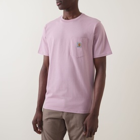 Model wearing Carhartt Pocket Logo T-Shirt in Hortensia pink, crew neck, short sleeves, chest patch pocket with logo badge, styled with khaki trousers