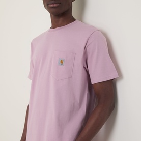 Model wearing Carhartt Pocket Logo T-Shirt in Hortensia pink, featuring chest patch pocket with logo badge, crew neck, short sleeves.