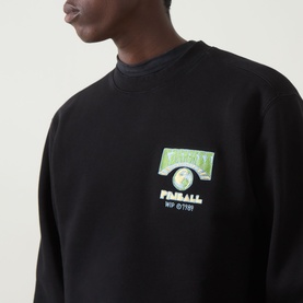 Model wearing Carhartt Pinball Logo Sweatshirt in Black, crew neck with Pinball graphic chest print, close-up detail shot.