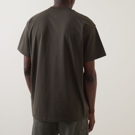 Model wearing Carhartt Gracious Logo T-Shirt in Cypress, rear view showing dropped shoulders, crew neck, and straight hem.