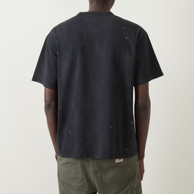 Model wearing Carhartt Painter Logo T-Shirt in black, rear view showing distressed destroy wash finish, dropped shoulders, straight hem, olive