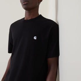 Model wearing Carhartt Madison Logo T-Shirt in black with white embroidered C logo on chest, short sleeves, crew neck, relaxed fit
