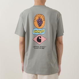 Model wearing Carhartt Stacked Grapes Logo T-Shirt in Shady Green, back view showing stacked grapes and Carhartt logo graphic print.
