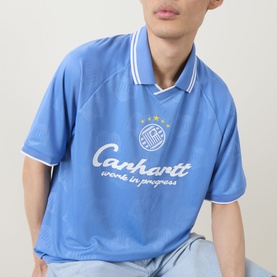 Model wearing Carhartt Terrace Logo Football T-Shirt in Curacao blue with polo collar, white tipping, and chest graphic print.