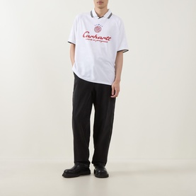 Model wearing Carhartt Heart Train T-Shirt in white with red script logo, styled with black wide-leg trousers and black shoes.