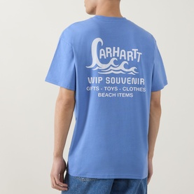 Model wearing Carhartt Waves Logo T-Shirt in Curacao blue, rear view showing WIP Souvenir waves graphic print, short sleeves, crew neck