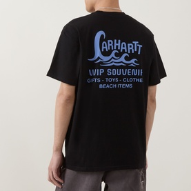 Model wearing Carhartt Waves Logo T-Shirt in black, showing back graphic with wave design and WIP Souvenir text print.
