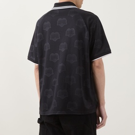 Model wearing Carhartt Heart Train/Black polo shirt, back view, with all-over tonal graphic print and striped collar trim