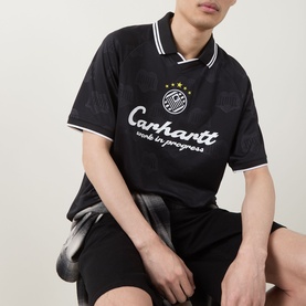 Model wearing Carhartt Heart Train Jersey T-Shirt in black with white tipping, logo print, styled with matching black shorts