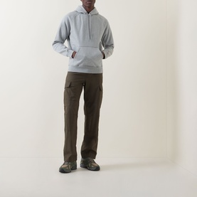 Model wearing Carhartt Chase Logo Hoodie in Grey Heather/Gold with brown cargo trousers and grey hiking shoes.