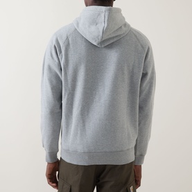 Model wearing Carhartt Chase Logo Hoodie in Grey Heather, back view showing raglan sleeves, kangaroo pocket and adjustable drawstring hood