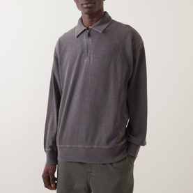 Model wearing Carhartt Harper Heavyweight Polo Shirt in Tobacco, long sleeves, half-zip, flat collar, styled with khaki trousers.