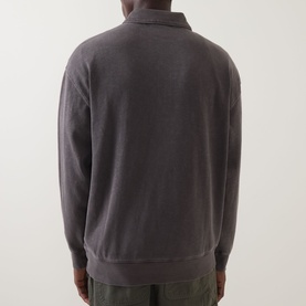 Model wearing Carhartt Harper Heavyweight Polo Shirt in Tobacco, rear view showing dropped shoulders, ribbed hem and half-zip collar
