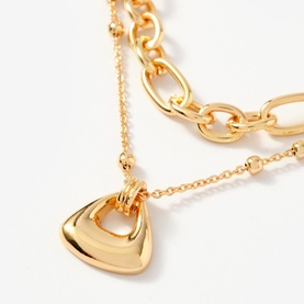 Mint Velvet gold layered necklace with chunky chain, fine ball chain, and polished triangular pendant drop
