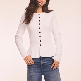 Model wearing Mint Velvet white ribbed button-front peplum top with long sleeves, styled with blue jeans.