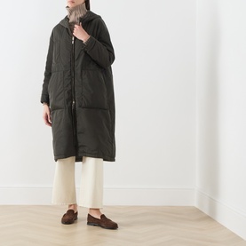 Model wearing Max Mara Cube Bosco Quilted Coat in kaki, styled with cream wide-leg trousers and brown loafers