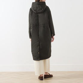 Model wearing Max Mara Cube Bosco Quilted Coat in kaki, longline silhouette with hood, back view, styled with cream wide-leg trousers.
