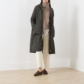 Model wearing Max Mara Cube Bosco Quilted Coat in kaki, styled with cream wide-leg trousers, ribbed turtleneck and brown loafers