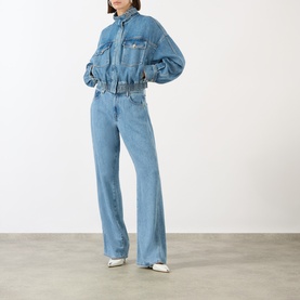 Model wearing Max Mara Sportmax Bussola Denim Bomber Jacket in Midnight Blue with matching wide-leg denim jeans and white trainers.