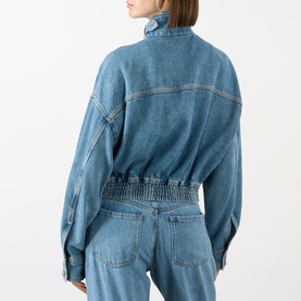 Model wearing Max Mara Sportmax Bussola Denim Bomber Jacket in Midnight Blue, back view, with matching denim trousers