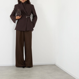 Model wearing Max Mara Sportmax cocoa belted jacket with wide-leg trousers, carrying a small brown bag