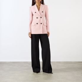 Model wearing Max Mara Sportmax Antique Rose virgin wool double-breasted blazer with dark buttons, styled with wide-leg black trousers.