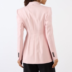 Model wearing Max Mara Sportmax Antique Rose virgin wool blazer, back view, with black tailored trousers and dark buttons.
