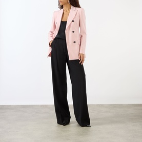 Model wearing Max Mara Sportmax Antique Rose double-breasted wool blazer, styled with black wide-leg trousers and a dark cami top.