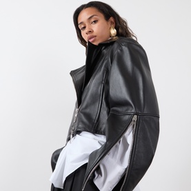 Model wearing Max Mara Sportmax Vicario Fringed Leather Jacket in black, cropped with asymmetric zip, styled with white shirt and black turtleneck